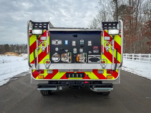Straight rear view with open control panel and warning chevrons.